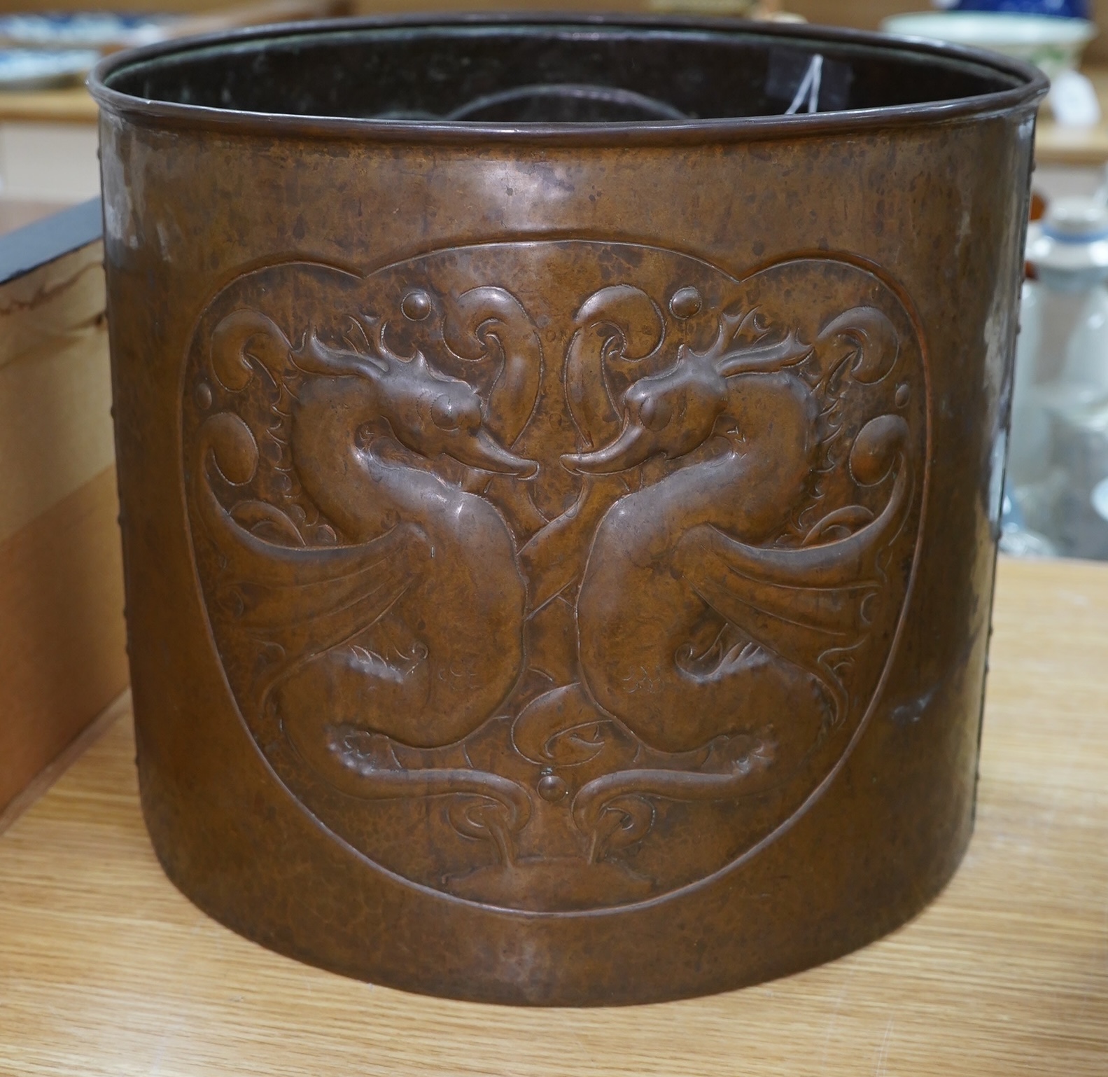 A large Arts and Crafts embossed copper jardiniere decorated with seahorses, stamped Newlyn to base, 28cm high, 33cm in diameter. Condition - good